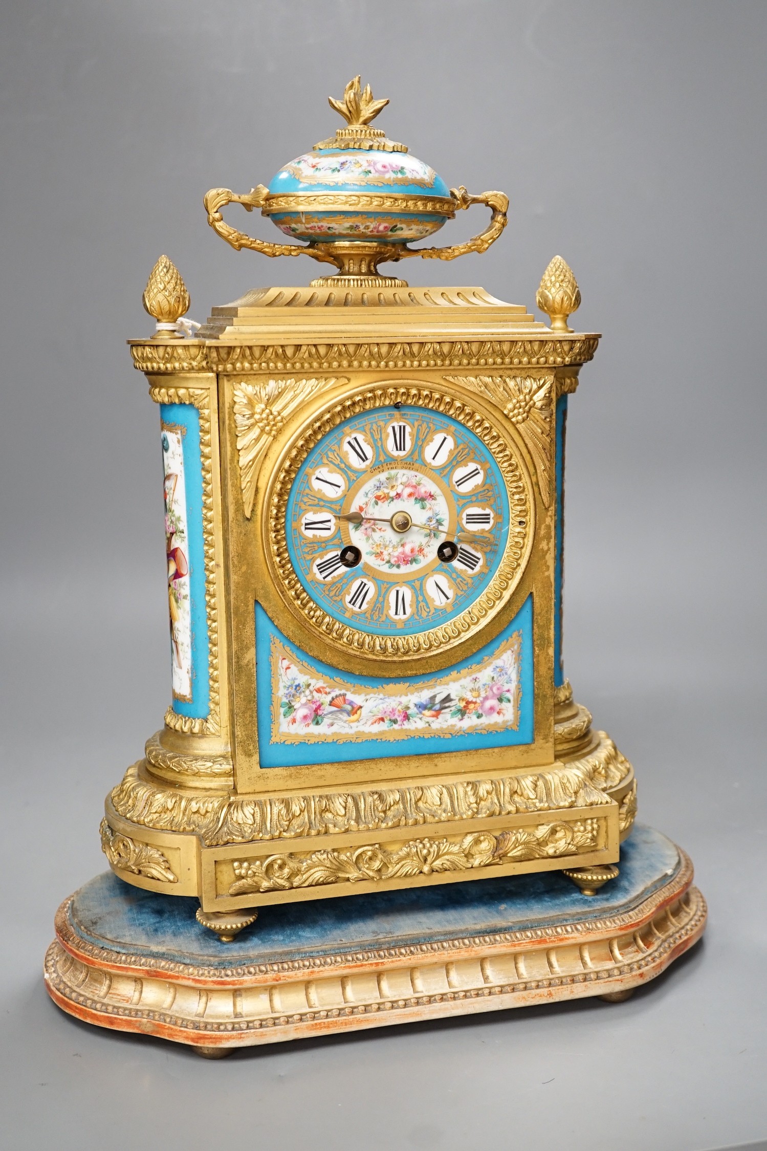 A French ormolu mantel clock, with inset floral decorated porcelain plaques and dial, 34cm high